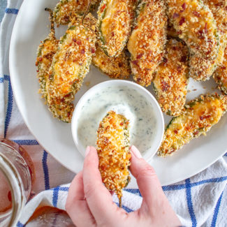 Baked Jalapeño Poppers are filled with cream cheese, cheddar cheese, and Monterey jack cheese, coated in a crispy breadcrumb coating and baked. It's a slightly healthier take on the popular appetizer.