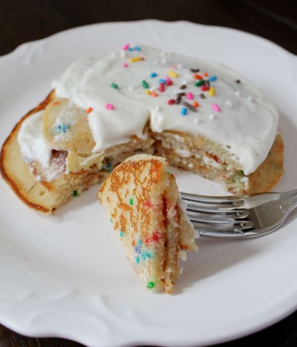 Funfetti Cupcake Pancakes | Pancakes made with funfetti batter served with a whipped vanilla frosting. It's the ultimate indulgent breakfast.