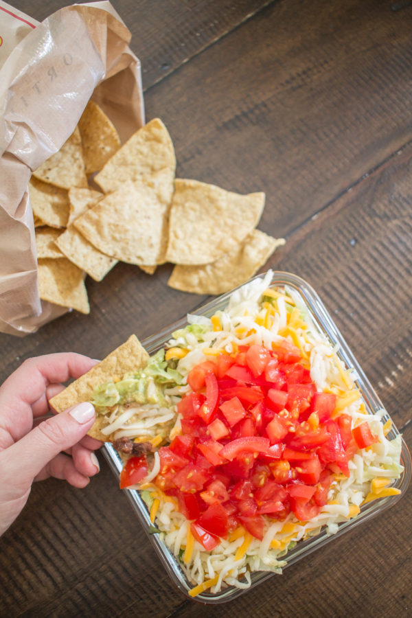 The Best 7 Layer Taco Dip | My recipe for 7 Layer Taco Dip brings together 9 simple ingredients to create 7 delicious layers of taco goodness. The only steps to prepare the dip are mixing sour cream with taco seasoning, mashing avocado with some lime juice, some chopping, and assembly. The hardest part of making 7 layer taco dip is not eating it all yourself.