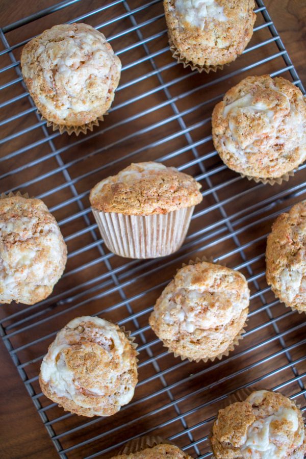 These carrot cake muffins are made with plenty of carrot seasoned with cinnamon, vanilla, and a touch of nutmeg. The result is a moist flavorful muffin. The finishing touch is adding a swirl of sweetened cream cheese on the top of the cupcakes before cupcakes go in the oven to bake.