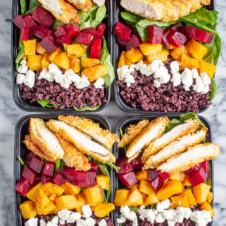 Crispy Chicken and Superfood Salads | These superfood salad bowls are a delicious way to eat your veggies. Spinach is topped with beets, butternuts squash, goat cheese, black rice, and crispy chicken - then drizzled with ranch dressing.