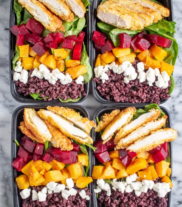 Crispy Chicken and Superfood Salads | These superfood salad bowls are a delicious way to eat your veggies. Spinach is topped with beets, butternuts squash, goat cheese, black rice, and crispy chicken - then drizzled with ranch dressing.