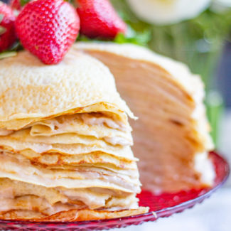 Roasted Strawberry Crepe Cake is made with 25 layers of crepes with roasted strawberry custard spread between each individual layer. The result is a slightly sweet cake that can easily serve 14-16 people. (But maybe less because it is so delicious that people might want seconds).
