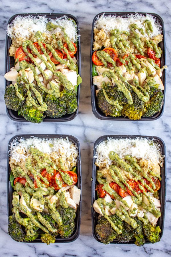 Pesto Salad Bowls are made with fresh baby spinach, quinoa, roasted tomatoes, roasted broccoli, diced chicken, parmesan, and pesto. Perfect for meal prep!