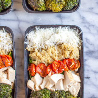Pesto Salad Bowls are made with fresh baby spinach, quinoa, roasted tomatoes, roasted broccoli, diced chicken, parmesan, and pesto