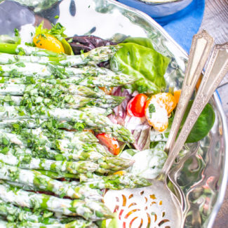 Asparagus Salad | This easy to prepare Asparagus Salad is bursting with fresh flavors. Cooked asparagus, grape tomatoes, mandarin oranges, and red onion are placed on top of mixed greens and then drizzled with a light lemon tarragon yogurt dressing. Serve it as a side dish, or add chicken or salmon to turn it into a complete meal.