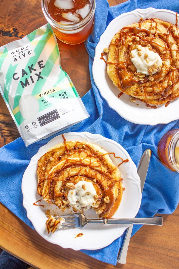 These decadent Cinnamon Roll Pancakes are made with vanilla cake batter swirled with cinnamon sugar, and topped with toffee sauce and cream cheese frosting. They are an over-the-top treat to serve for a birthday or special occasion.