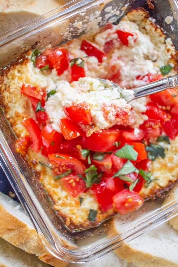 This easy Baked Goat Cheese brings together the summer flavors of fresh tomatoes, basil, and lemon for a lighter take on a classic appetizer. This simple is the perfect thing to serve at a party.