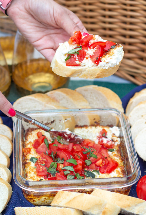 This easy Baked Goat Cheese brings together the summer flavors of fresh tomatoes, basil, and lemon for a lighter take on a classic appetizer. This simple is the perfect thing to serve at a party.