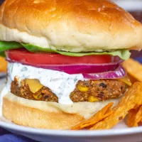 Sweet Potato and Black Bean Veggie Burgers are a great way to eat your veggies. These burgers are made by combining sweet potatoes, black beans, corn, shallots, garlic, quinoa, and old-fashioned oats. It is a plant-based meal that you feel good about eating.