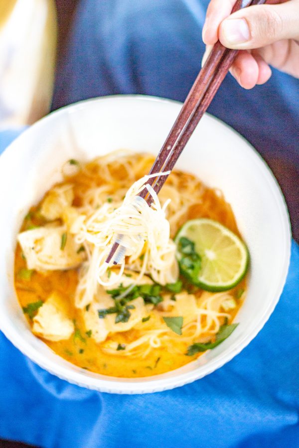 Thai Curry Noodle Soup with Chicken | We are obsessed with this Thai Curry Noodle Soup with Chicken recipe. It's so flavorful - it's spicy, creamy, and citrusy with thin strands of rice noodles and chunks of tender chicken. It is also an easy to prepare weeknight meal that is anything but boring.