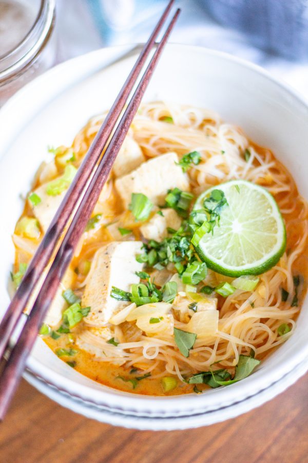 Thai Curry Noodle Soup with Chicken | We are obsessed with this Thai Curry Noodle Soup with Chicken recipe. It's so flavorful - it's spicy, creamy, and citrusy with thin strands of rice noodles and chunks of tender chicken. It is also an easy to prepare weeknight meal that is anything but boring.