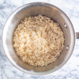 Once the risotto has absorbed the broth, taste it to make sure that it has cooked enough. Then season with salt, and add in any vegetables and cheese that you like.