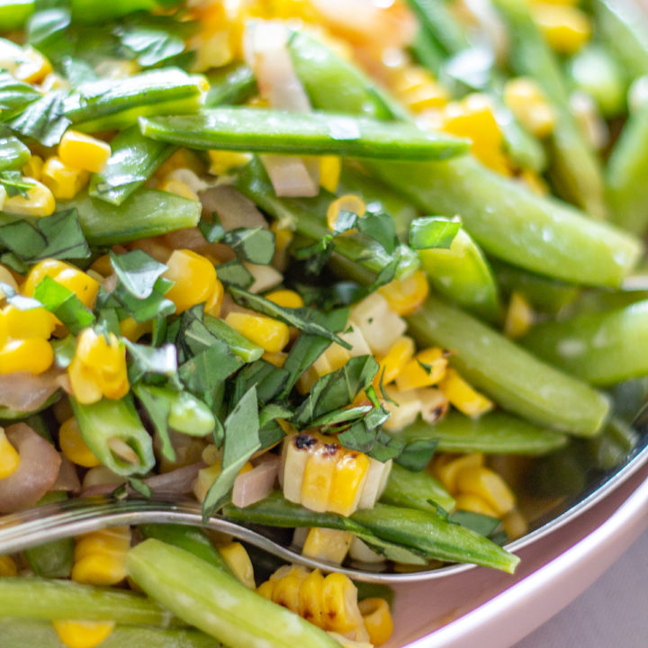 Sugar Snap Pea and Corn Salad | This Sugar Snap Pea and Corn Salad with caramelized shallots and a citrus yogurt dressing is an untraditional addition to Thanksgiving dinner that my family loves.