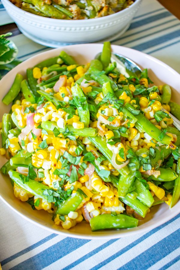 Sugar Snap Pea and Corn Salad | This Sugar Snap Pea and Corn Salad with caramelized shallots and a citrus yogurt dressing is an untraditional addition to Thanksgiving dinner that my family loves.