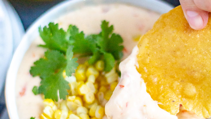 Corn Queso | This creamy cheesy corn queso is loaded with fresh steamed corn, tomatoes, and green chilies. #queso #dip