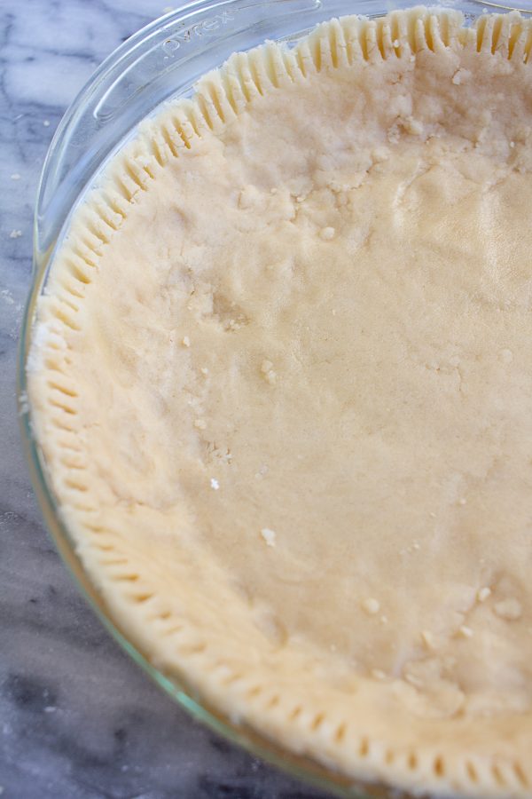 This 4 ingredient no roll pie crust recipe is the easiest way to make a pie crust from scratch! This shortbread pie crust makes holiday baking much easier!