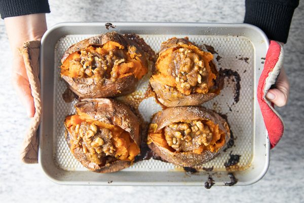 Twice Baked Sweet Potatoes are mashed with butter, maple syrup, and sea salt, and then topped with a butter, pecan, and brown sugar topping. It’s the ultimate combination of sweet, salty, and nutty flavors. 
