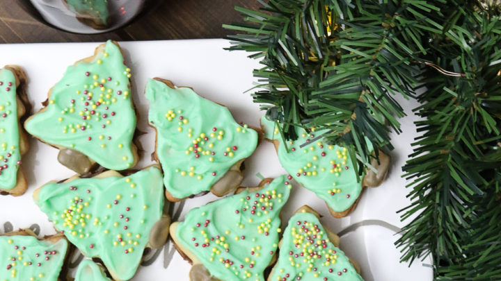 Christmas Tree Sugar Cookie Sandwiches | These Christmas tree shaped sugar cookie sandwiches are filled with Nutella and topped with white chocolate and sprinkles - they are just the cookie to serving at a holiday party or to bring to a cookie swap. #cookies #christmascookies