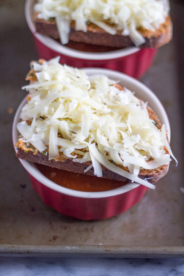 Tomato Soup with Cheesy Toast | This recipe is a new way to serve a classic meal. Tomato soup and grilled cheese belong together. Instead of serving a sandwich with my tomato soup, I served my tomato soup with cheesy toast on top. #soup