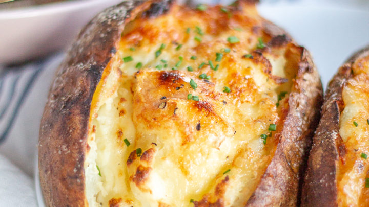Twice Baked Brie Potatoes are baked potatoes with crispy salty skins that are filled with creamy mashed potatoes made with brie, sour cream, garlic, and parmesan.