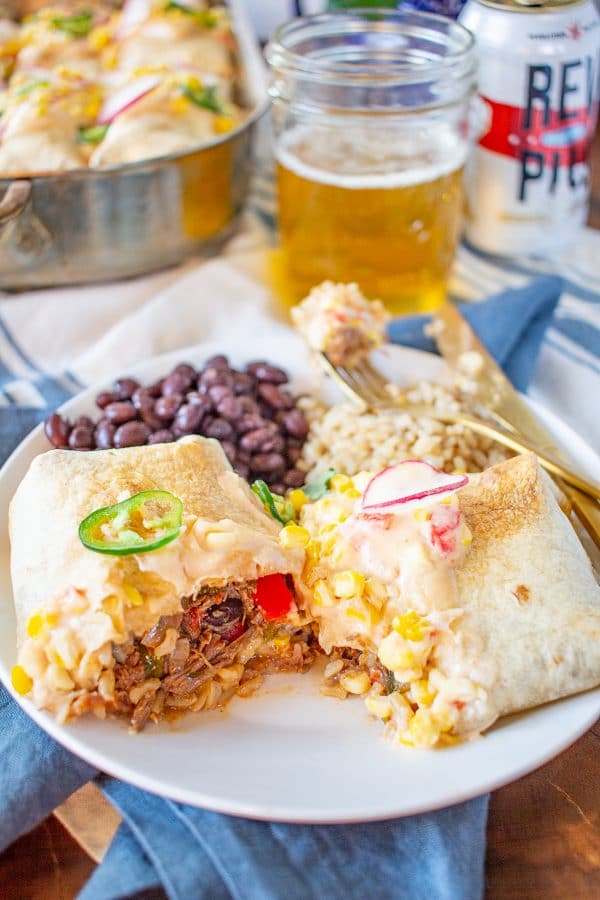 Shredded Beef Chimichangas | Shredded Beef Chimichangas are filled with tender spicy shredded beef, rice, refried beans, sautéed bell peppers and zucchini, tomatoes, and cheese.