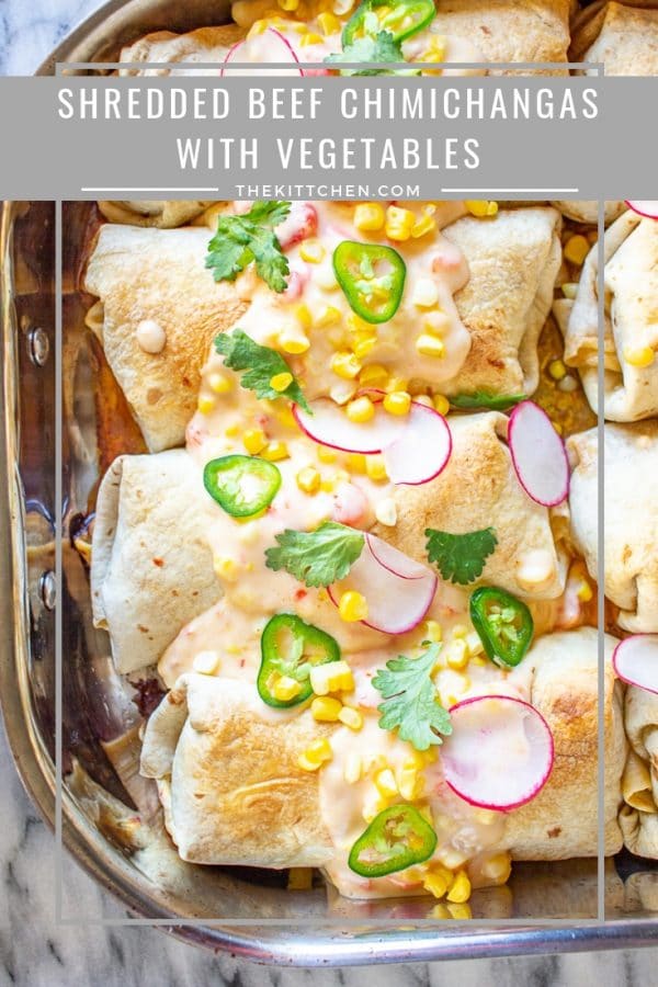 Shredded Beef Chimichangas | Shredded Beef Chimichangas are filled with tender spicy shredded beef, rice, refried beans, sautéed bell peppers and zucchini, tomatoes, and cheese.