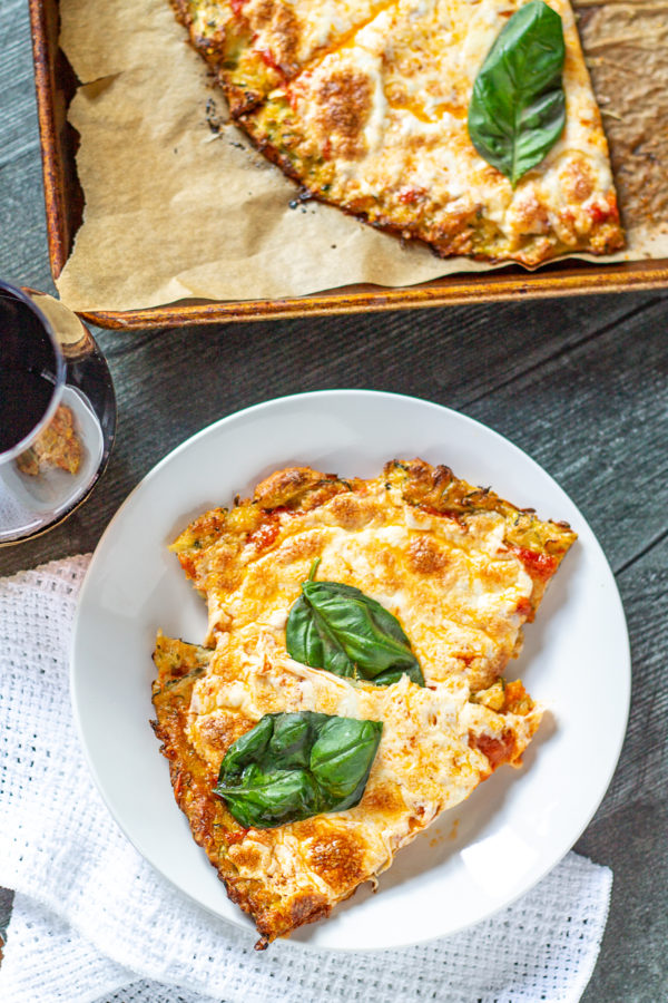 Easy Zucchini Pizza Crust| This gluten free Zucchini Pizza Crust is easy to make with six ingredients. Plus, it's a delicious way to eat more vegetables!