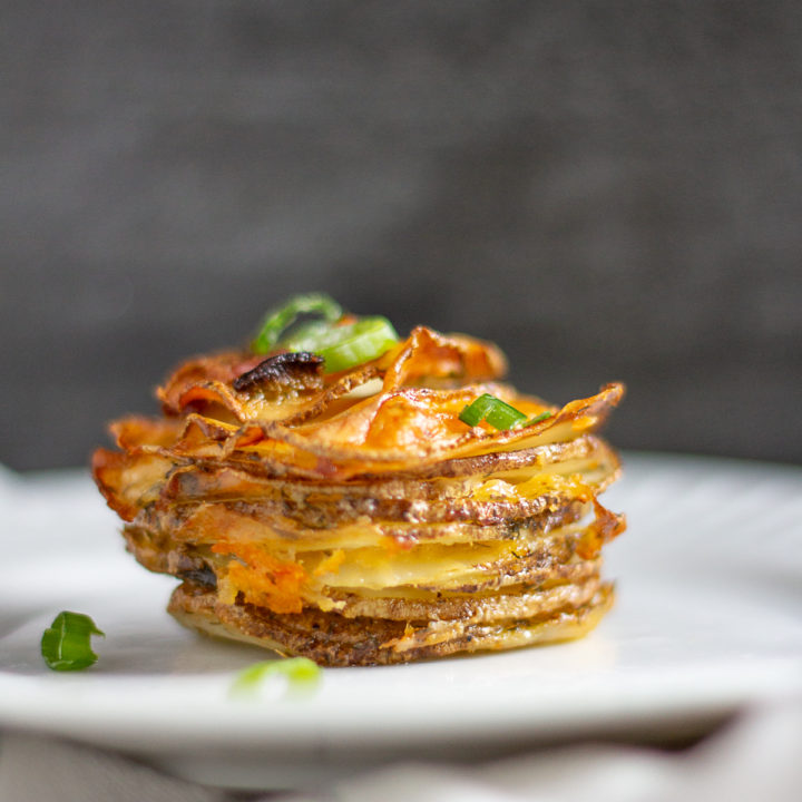 Bacon Cheddar Ranch Potato Stacks are thin slices of potato seasoned with dry ranch dressing and layered with cheddar cheese and bacon. 