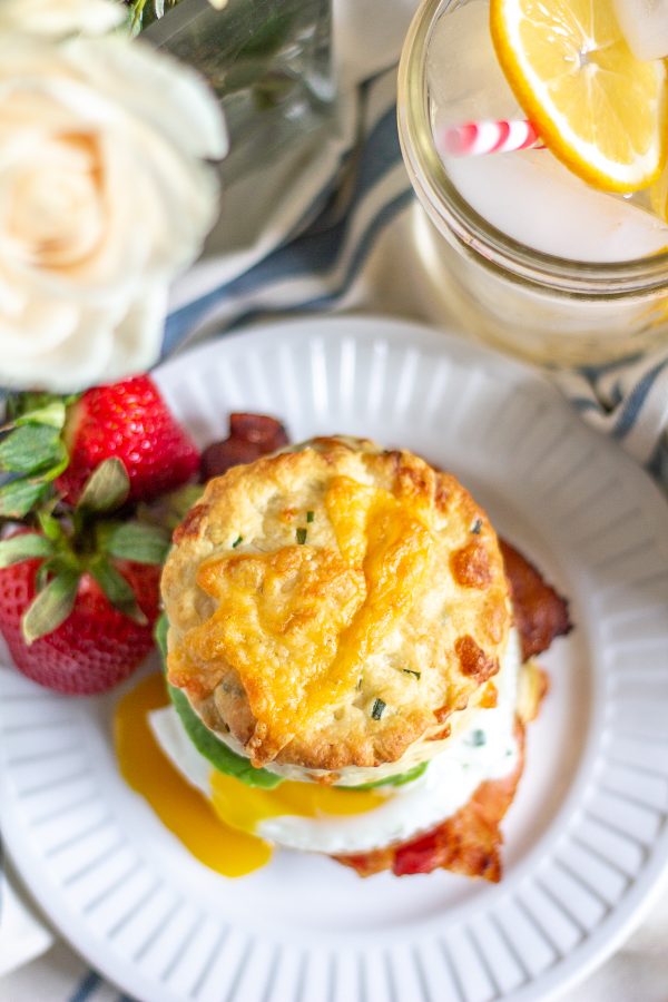 The Best Breakfast Sandwich | This meal is a way to get your day off to a great start. This breakfast sandwich is made with a fried egg, bacon, and avocado on a homemade cheddar cheese and green onion biscuit. The finishing touch is a drizzle of ranch dressing.