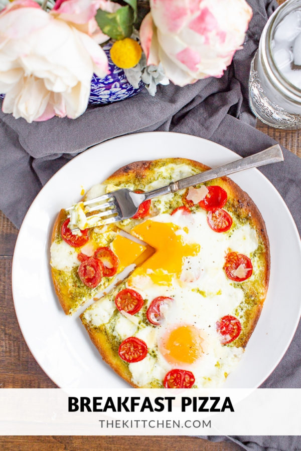 Breakfast Pizza | Breakfast pizza is a delicious homemade breakfast that can be made in under 20 minutes. Frozen naan gets topped with pesto, tomato, cheese, and eggs for a simple meal.