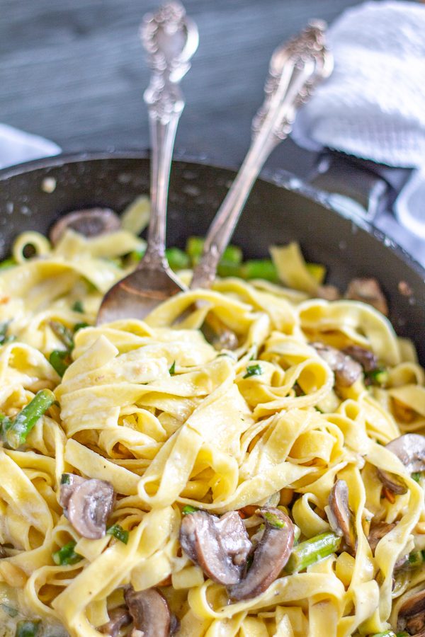 Creamy Pasta with Asparagus and Mushrooms is a meal that can be made in just 20 minutes. Fresh pasta is coated in a light parmesan and mascarpone sauce and tossed with sauteed mushrooms and al dente asparagus. Serve it as a complete meal or as a side dish.