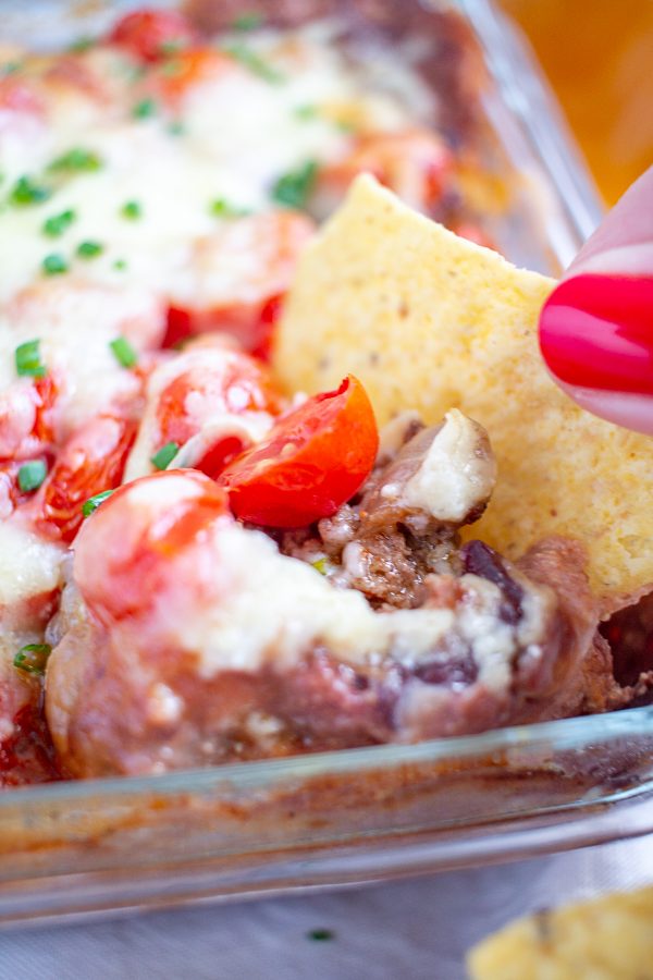 Baked Taco Dip | A six layer taco dip with ground beef, cheese, and refried beans
