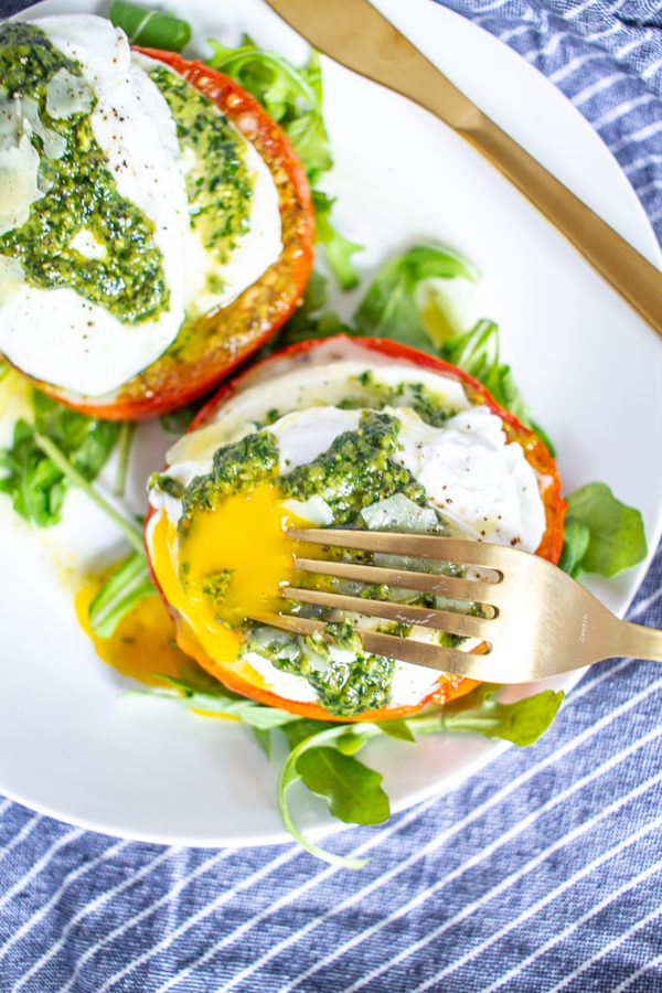 Caprese Eggs Benedict is an easy to make twist on traditional Eggs Benedict made with roasted tomatoes, mozzarella, pesto, and poached eggs. It's one of my favorite breakfasts to make at home over the weekend.