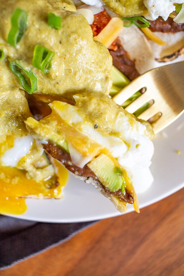Mexican Eggs Benedict consists of poached eggs, crumbled bacon, cheddar cheese, slices of avocado, and refried beans on flour tortillas topped with poblano cream sauce. It's an extra special breakfast you can make at home.