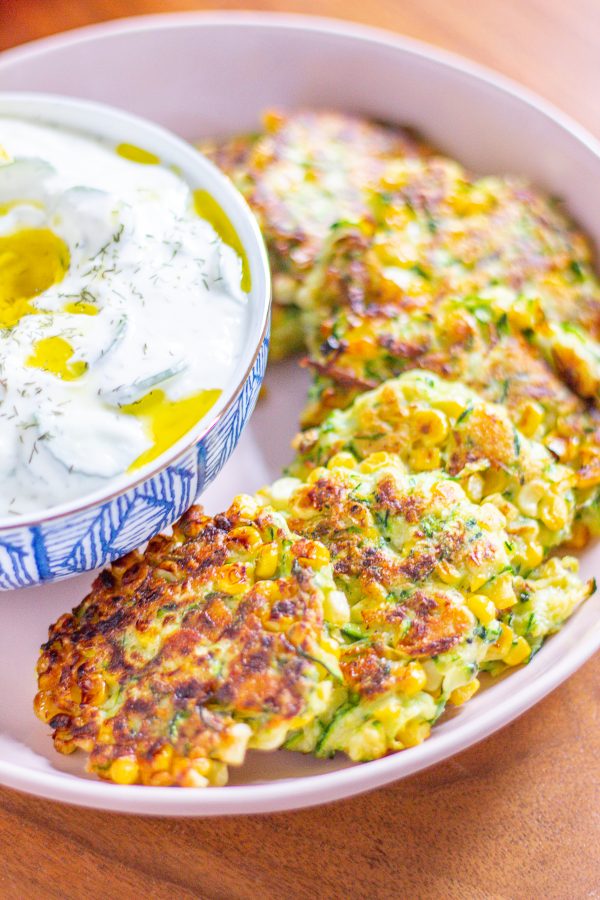 Zucchini and Corn Fritters are crispy little cakes of corn and shredded zucchini seasoned with Pecorino Romano, garlic, and lemon juice. Serve them as an appetizer or side dish!
