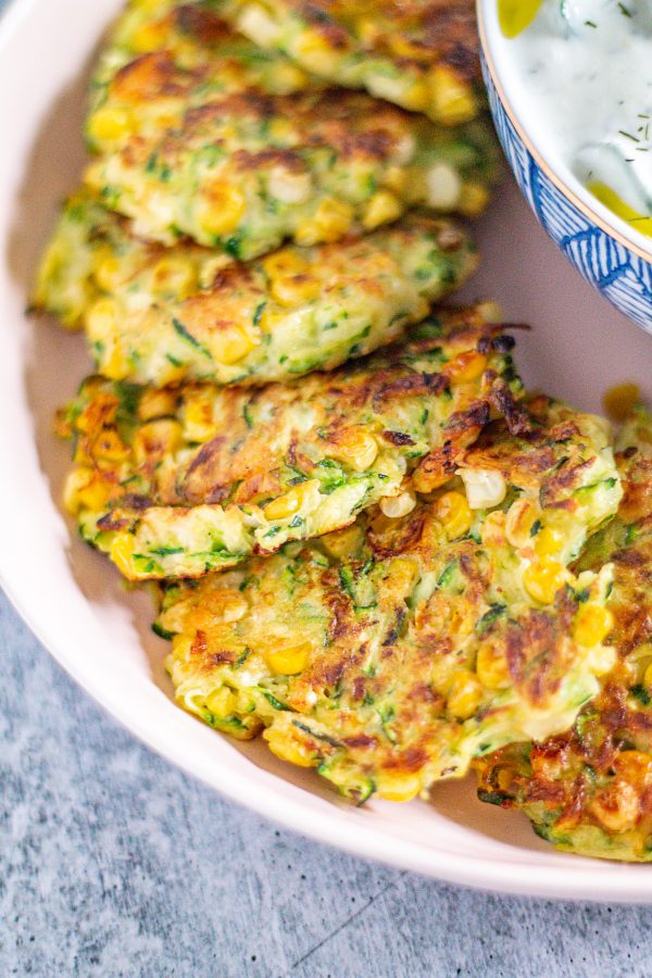Zucchini and Corn Fritters are crispy little cakes of corn and shredded zucchini seasoned with Pecorino Romano, garlic, and lemon juice. Serve them as an appetizer or side dish!