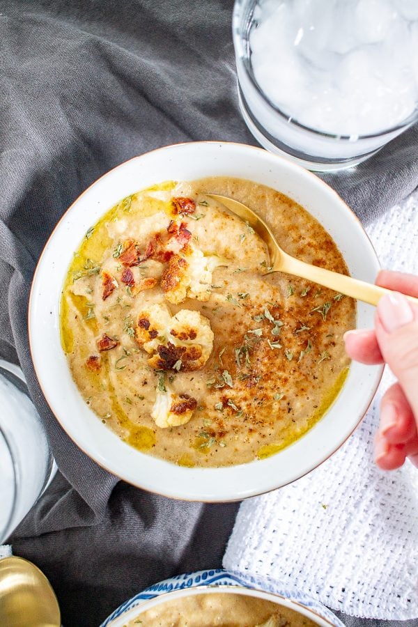 A rich and creamy caramelized onion and cauliflower soup that is the perfect healthy comfort food meal.